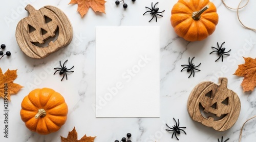 Halloween flat lay with blank paper, pumpkins, wooden jackolanterns, spiders, and autumn leaves isolated on white background