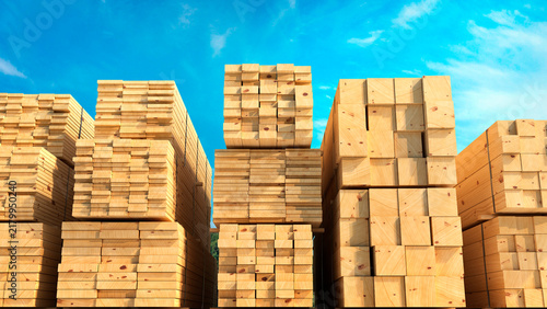Stacks of freshly cut wooden lumber and timber beams stored outdoors in a sawmill or timber yard, with natural wood grain,