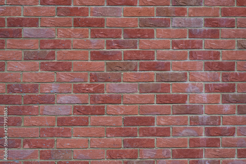 Naklejka Red brick wall texture background with regular brickwork pattern and natural color variation