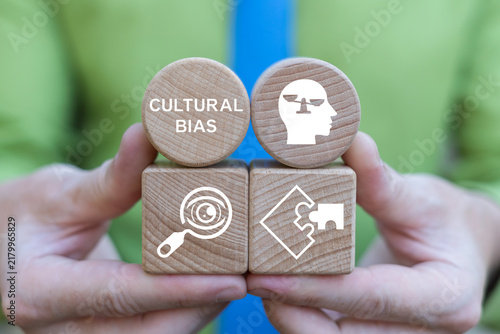 Cultural bias concept. Business person holding blocks with the inscription CULTURAL BIAS. Discrimination or diversity awareness.
