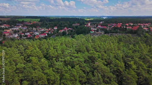 Stare Juchy Poland Aerial Drone View over Masuria Village and Lakes on summer day. Town reveal over trees.