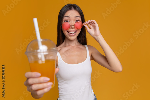 Excited woman surprised by refreshing summer drink