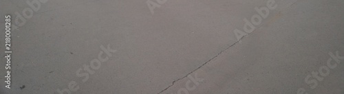 A Close Up View Of A Single Thin Hairline Crack On A Smooth Grey Concrete Surface Texture Background