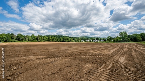 Freshly leveled dirt ground prepped for upcoming construction or landscaping projects.