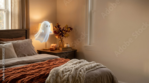 Cozy bedroom with warm lighting, autumn decor, knitted blanket, and white ghost floating near bedside lamp creating playful and inviting atmosphere