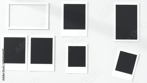 Collection of blank vintage instant photo frames and a rectangular picture frame arranged for display