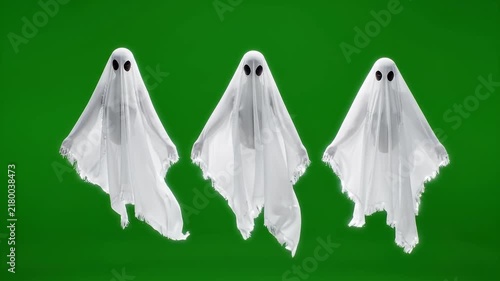 People dressed as ghosts moving against a green screen background on transparent background