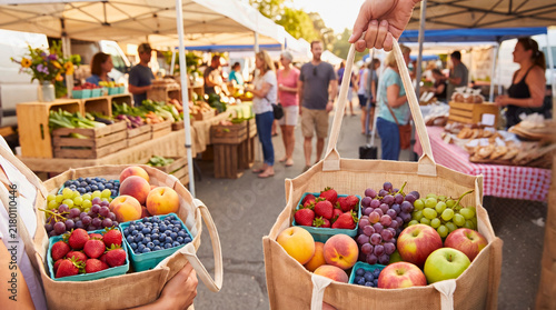 Fresh seasonal fruit baskets at bustling outdoor farmers market with captures vibrant fresh produce baskets filled ripe strawberries