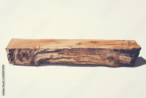 A natural, rough-hewn piece of light brown timber.