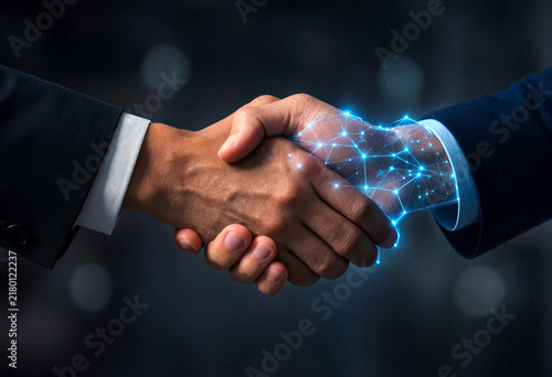 Business partnership handshake with digital network connection concept illustrating technology and collaboration
