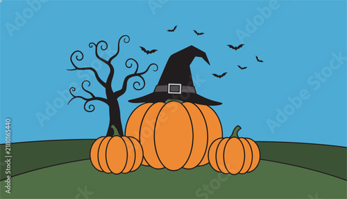 Large pumpkin wearing a black witch hat stands in a green field with a barren tree and bats flying against a bright blue sky for halloween.