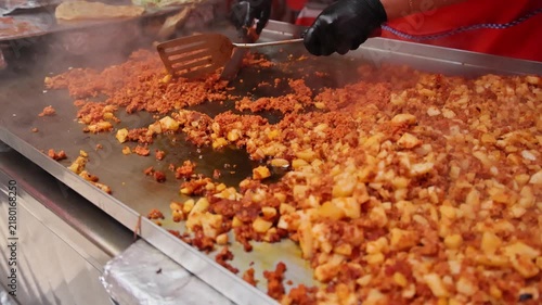 Street Vendor Cooking Chorizo And Potatoes On Griddle In Mexico City Market