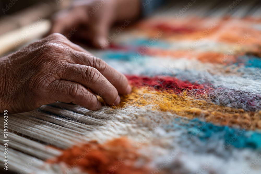 Fototapeta premium Hands gently press fabric on loom. Colors blend in soft, textured pattern. Artistry in weaving, timeless, quiet craft. Ideal for design, culture, or artisan-themed projects
