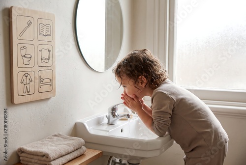 Child Using Visual Routine Board For Independent Daily Activities