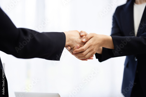 Close-up of the hands of a businesswoman shaking hands with a client