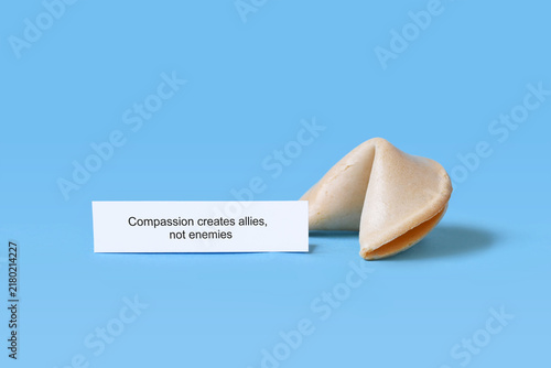 Konstfotografi Fortune cookie with motivational text saying 'Compassion creates allies, not ene
