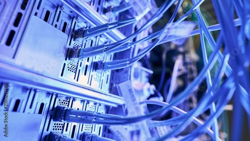 Konstfotografi High speed blue fiber optic cables connected to server rack equipment with techn
