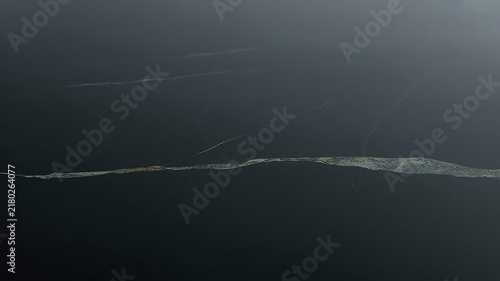 Dark marble texture with subtle gold veins creates a dramatic stone background