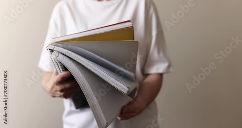 Person holding notebooks and folders, person holding notebooks and folders, notebook theme, study theme, lifestyle theme
