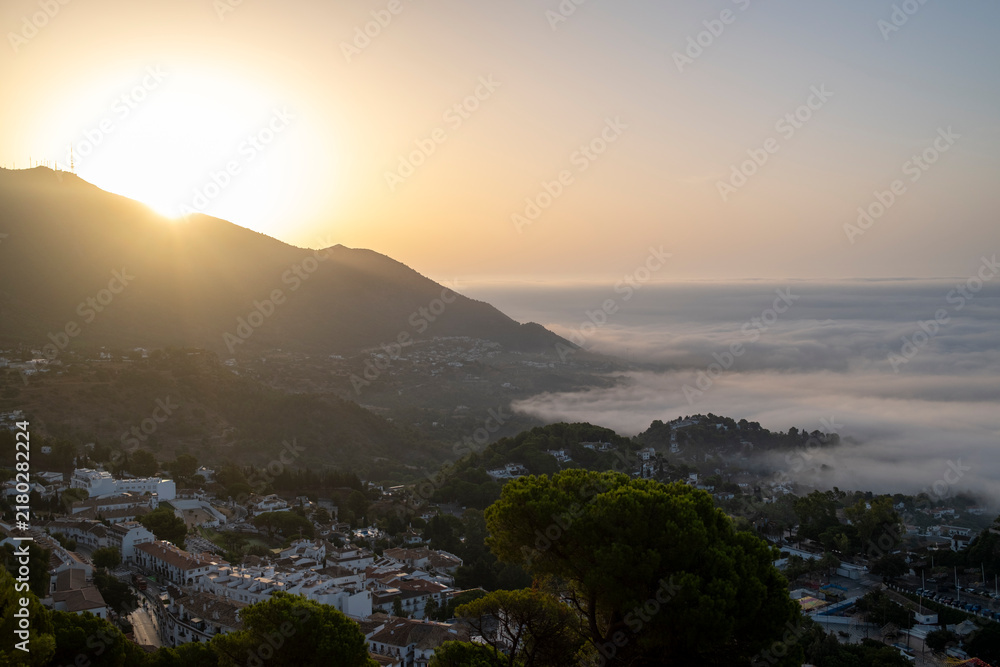 Fototapeta premium Mijas, Málaga, Spain – Mountain landscape and whitewashed village above the clouds at sunset