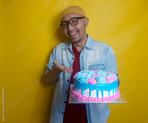 Cheerful Asian Guy Showing A Birthday Cake That He Made To The Camera