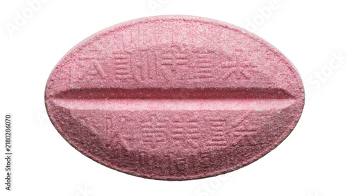Принти на полотні Oval pink pill with embossed Asian characters and a central score, isolated on t