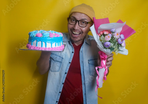 Young Asian Man Showing Birthday Cake And A Bouquet Flowers With Happy Expression