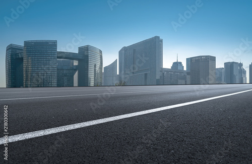 Asphalt Road Leading to Modern Urban Skyscrapers