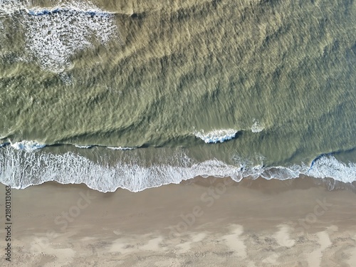 Картината върху платно Aerial View of Waves Breaking on a Sandy Beach Along the North Sea Coast in the