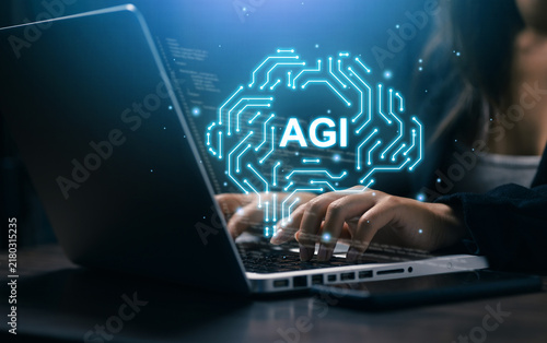 Professional uses laptop with glowing AGI brain interface, representing artificial general intelligence, machine learning, automation, advanced computing, innovation, and future technology.