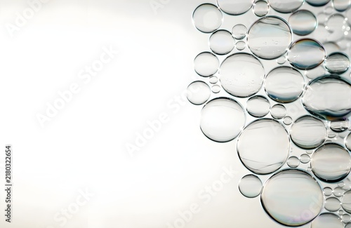 transparent soap bubbles floating together in a natural cluster concentrated along one side of the frame with the opposite side intentionally uncluttered and open for copy space

