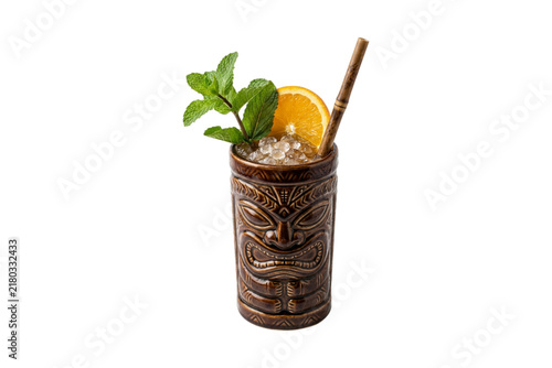 Tiki cocktail in a themed mug with mint and orange creates a refreshing tropical drink.