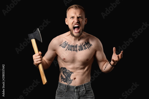 Картината върху платно Aggression and anger management, shirtless man screaming with an axe in hand exp