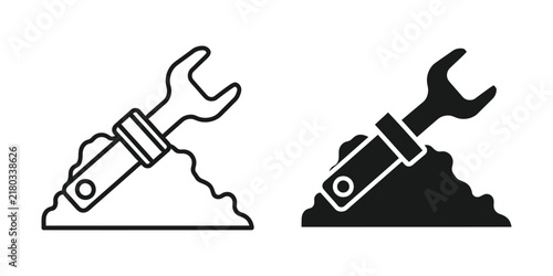 Wrench emerging from soil during construction with copy space for business concepts