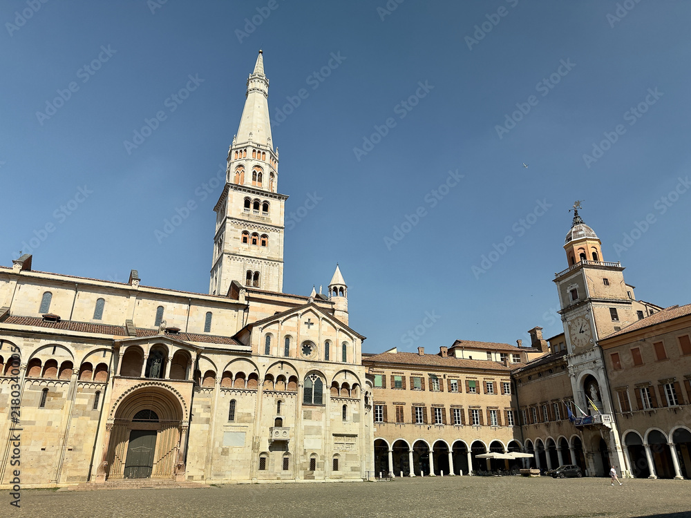 Fototapeta premium Modena Cathedral and Ghirlandina tower viewed from Piazza Grande on a bright sunny summer day, Emilia-Romagna, Italy. 