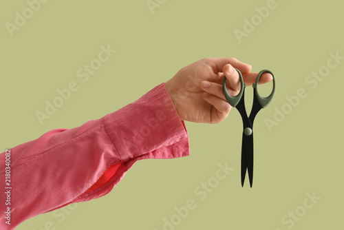 Konstfotografi Budget cuts and cost reduction concept, hand holding scissors to represent finan