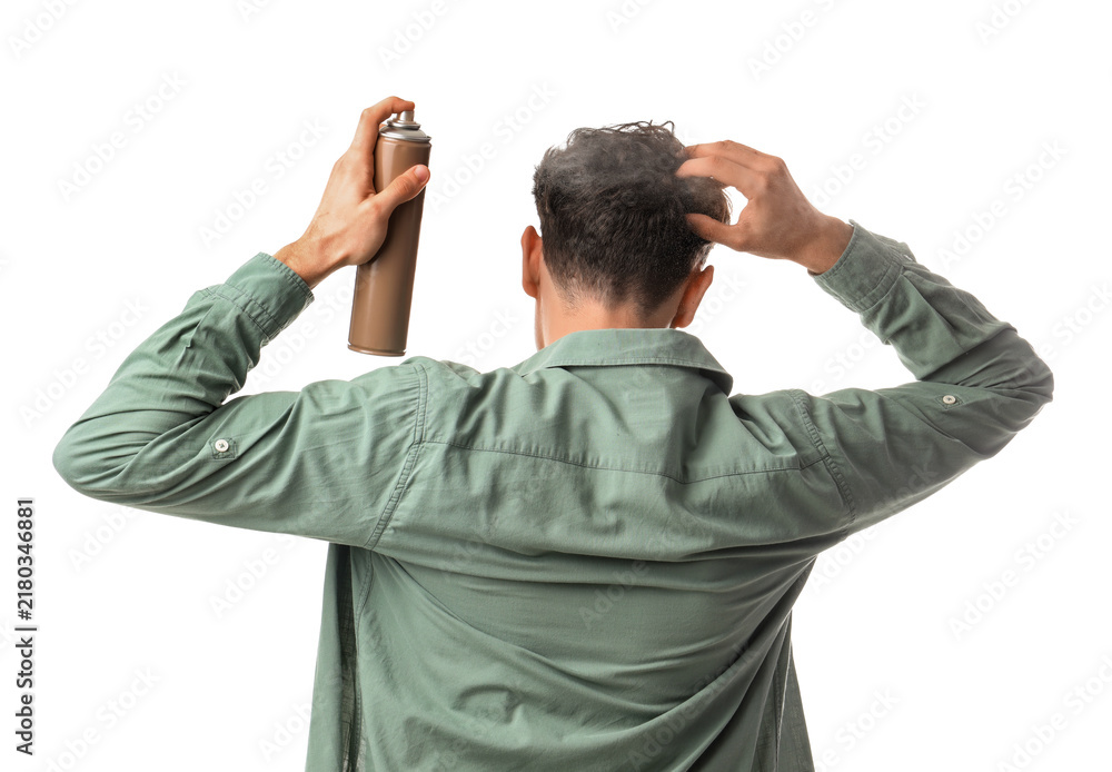 Obraz premium Handsome young man applying hairspray on his curly hair against white background, back view