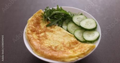 zucchini casserole with cucumber and green salad in a plate on the table
