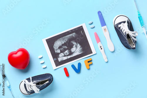 Abbreviation IVF with sonogram image, pregnancy tests, syringes and baby boot...