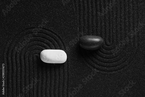 Canvas Print Stones on black sand with lines. Yin Yang concept