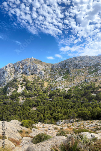 Konstfotografi Mountain landscape along the Cap de Formentor peninsula, in Pollença, on the island of Mallorca, Balearic Islands, Spain, with rocky peaks and sparse Mediterranean shrubland under a blue sky