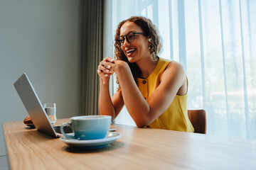 Stickers Chambre d’enfants Woman smiles during video call for remote work at office  © Jacob Lund