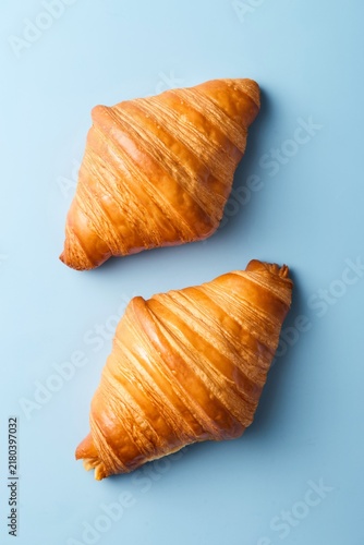 Croissants on blue background. Top view