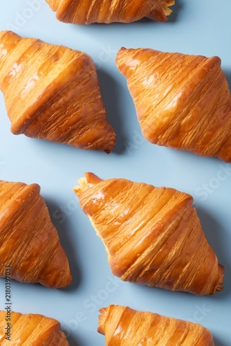Croissant pattern on a blue background. Top view