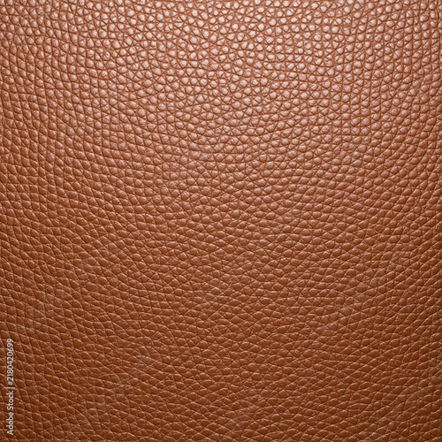 Brown pebbled leather texture close-up background