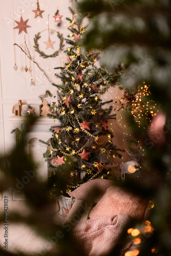 Decorated christmas tree in cozy living room with lights and ornaments