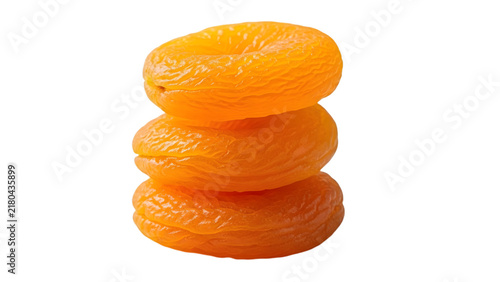 A vertical stack of three delicious dried apricots isolated on transparent background