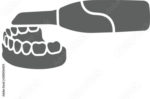 Grey silhouette icon of an electric toothbrush cleaning set of human teeth, isolated on a white background