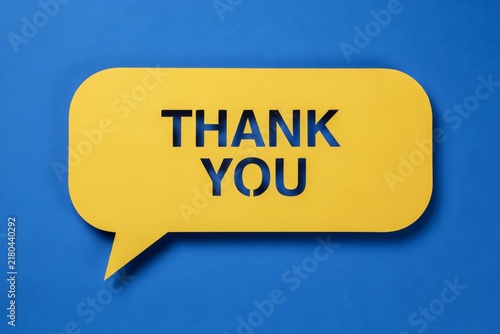 Yellow speech bubble with the words thank you cut out, placed on a vibrant blue background, conceptual design for communication and gratitude