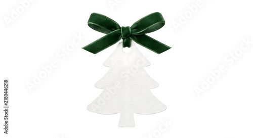 Bild auf Leinwand White christmas tree shaped gift tag with green velvet bow